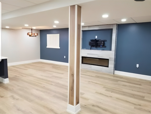 clean wood flooring in a new residential living room and dining room area with blue walls and recessed lighting